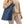 Laden Sie das Bild in den Galerie-Viewer, Fau in Teilansicht, von vorne, mit Blue Denim Tote Bag mit Logo Poppi & Peaseblossom